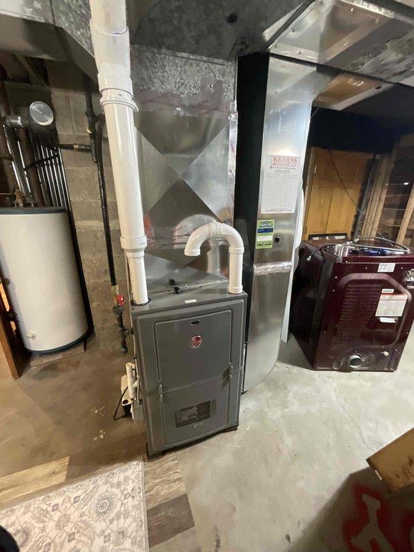 Conducted estimate for replacement of aging HVAC system located in basement utility room. Current setup includes older furnace unit with connected PVC ventilation piping, metallic ductwork, and adjacent water heater. Documented existing equipment condition and layout for proper sizing and configuration of replacement system.