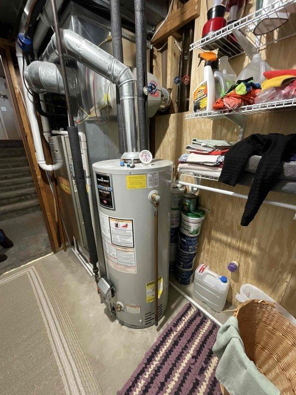 # Water Heater Replacement Estimate

Conducted on-site assessment for replacement of existing 40-gallon Bradford white water heater installed in 2010. Inspected current unit located in basement utility area, documented existing plumbing connections including hot and cold water supply lines with black foam insulation, galvanized vent ducting secured with metal straps, and verified clearances around unit. Evaluated installation space, measured available area for new equipment, and assessed condition of existing piping infrastructure. Photographed current water heater configuration, connection points, and surrounding workspace to prepare accurate replacement estimate. Confirmed customer preference for replacement of aging unit and gathered necessary specifications to provide comprehensive quote for new water heater installation including removal and disposal of existing equipment.