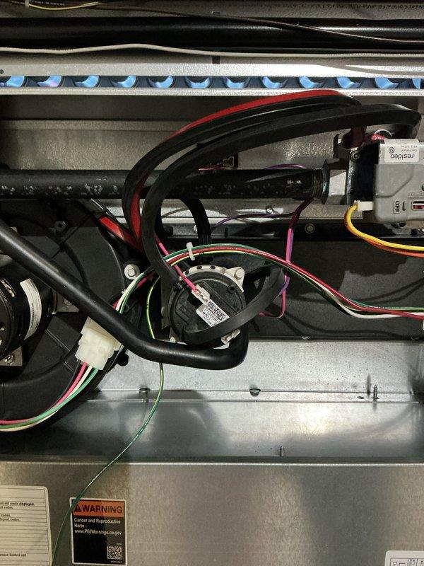 # HVAC Maintenance - AHM Service Report

Completed annual furnace tune-up and maintenance on a new 0-year-old heating system. Performed comprehensive inspection of all major components including burner assembly, heat exchanger, blower motor, and control module. Verified proper operation of blue flame burner ports and confirmed even flame distribution across burner assembly. 

Inspected and documented condition of air filter assembly, noting moderate accumulation of dust and debris on honeycomb mesh filter media. Examined refrigerant lines and condensate drainage system for proper routing and secure connections. Verified all electrical connections throughout the unit, including control board wiring harnesses, blower motor connections, and safety circuit components.

Tested furnace ignition sequence and confirmed proper operation of electronic control module and indicator lights. Inspected blower motor assembly and verified secure mounting and proper wire connections. Examined all visibl