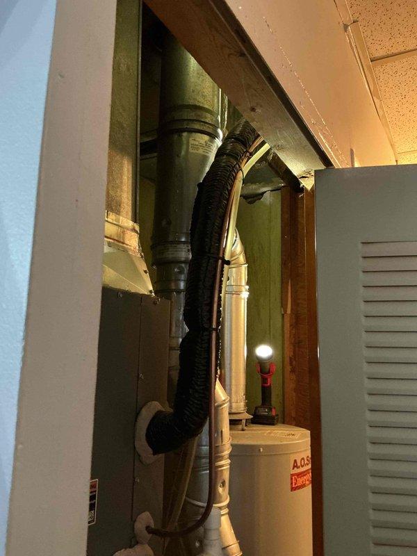 # Service Report: Tanked Water Heater Replacement

Responded to no hot water complaint on 10-year-old A.O. Smith tank-style water heater. Upon diagnostic inspection, determined unit had reached end of serviceable life and was no longer producing hot water due to failed heating element and sediment accumulation. Recommended full replacement rather than repair given age and condition of existing equipment.

Removed and properly disposed of old water heater from utility closet installation. Installed new A.O. Smith EnergySaver model tank water heater with appropriate BTU capacity for household demand. Connected new unit to existing water supply lines using copper piping with shutoff valve at inlet. Verified proper clearances for combustion air and maintenance access within confined closet space.

Installed metallic vent pipe and flue assembly to exhaust combustion gases safely through existing ventilation pathway. Ensured all gas connections were properly sealed and tested for leaks using