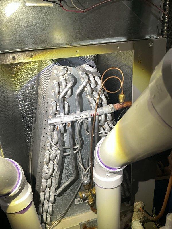 # HVAC Maintenance - ACM Service Summary

Completed annual cooling maintenance on Lennox HVAC system. Performed comprehensive inspection of evaporator coil assembly, verified proper refrigerant line connections and insulation integrity, and checked condensate drain lines for proper operation. All components found to be in satisfactory working condition with system operating within normal parameters.

---

## Detailed Service Report

Performed annual cooling maintenance (ACM) on residential Lennox HVAC system located in mechanical room. Conducted thorough inspection of air handler unit and evaporator coil assembly. Examined multi-row serpentine evaporator coil configuration, verifying clean coil surfaces and proper airflow through heat exchanger. Inspected metal housing and internal framework for structural integrity and signs of corrosion or deterioration.

Evaluated refrigerant line connections, including insulated copper suction line with characteristic orange insulation and liquid l