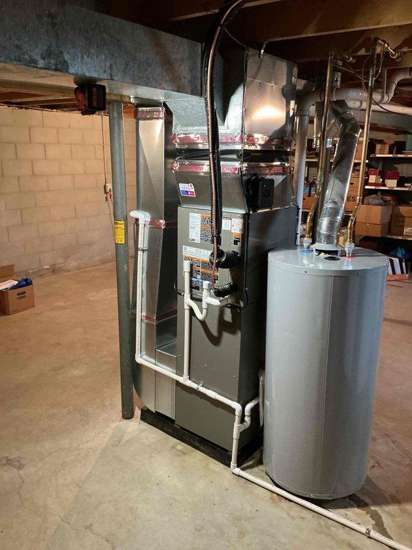 Completed full HVAC system installation including 70,000 BTU furnace with humidifier reconnection in basement mechanical room and matching outdoor air conditioning condenser unit with proper electrical disconnect. All equipment installed per manufacturer specifications, permits obtained, utility company notifications processed, and system tested for proper operation.