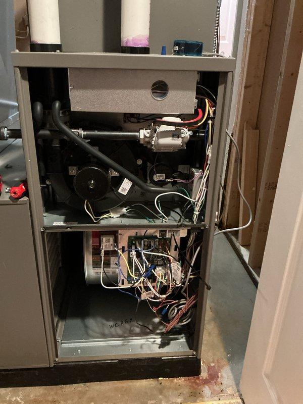 # Service Report

Responded to no heat call on 1-year-old furnace located in basement. Upon arrival, conducted diagnostic inspection of unit with access panels removed to identify cause of heating failure. Inspected all internal components including blower motor assembly, gas valve, pressure switches, condensate drain system, and electrical connections throughout upper and lower compartments. Verified proper operation of all mechanical and electrical systems. Checked venting system including PVC exhaust and intake pipes for proper installation and clearances. Examined wiring connections and found some disorganization but all connections secure and functional. Restored heat to unit and confirmed normal operation. Completed Annual HVAC Maintenance inspection as time permitted, including full system evaluation and performance verification. Documented equipment condition with photos showing internal components and overall unit configuration. Unit operating properly at time of departure. Pa