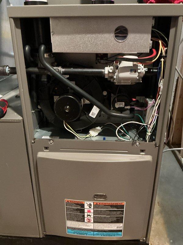 # Service Report

Responded to no heat call on 1-year-old furnace located in basement. Upon arrival, conducted diagnostic inspection of unit with access panels removed to identify cause of heating failure. Inspected all internal components including blower motor assembly, gas valve, pressure switches, condensate drain system, and electrical connections throughout upper and lower compartments. Verified proper operation of all mechanical and electrical systems. Checked venting system including PVC exhaust and intake pipes for proper installation and clearances. Examined wiring connections and found some disorganization but all connections secure and functional. Restored heat to unit and confirmed normal operation. Completed Annual HVAC Maintenance inspection as time permitted, including full system evaluation and performance verification. Documented equipment condition with photos showing internal components and overall unit configuration. Unit operating properly at time of departure. Pa