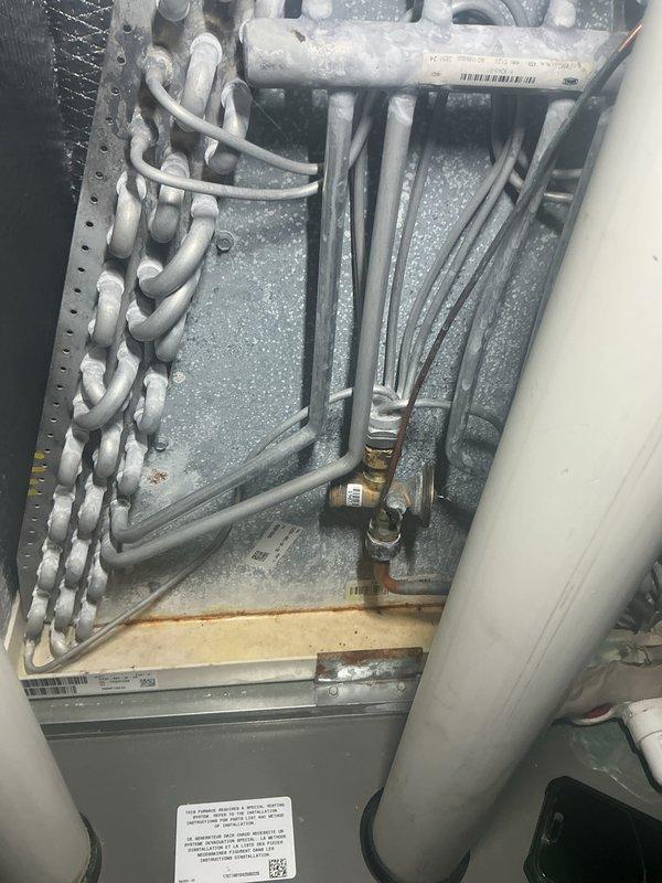 Completed annual cooling maintenance on residential HVAC system. Replaced air filter and discovered significant frost buildup on evaporator coil and interior components, indicating potential refrigerant restriction, airflow deficiency, or system malfunction requiring further diagnostic evaluation and repair.