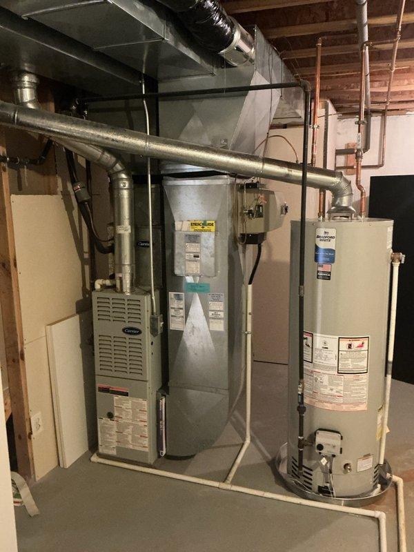 Completed annual HVAC maintenance on Carrier furnace system and inspected associated mechanical equipment in basement utility area. Performed routine system diagnostics, verified proper operation of heating components, checked ductwork connections, and documented equipment condition through photographic records.