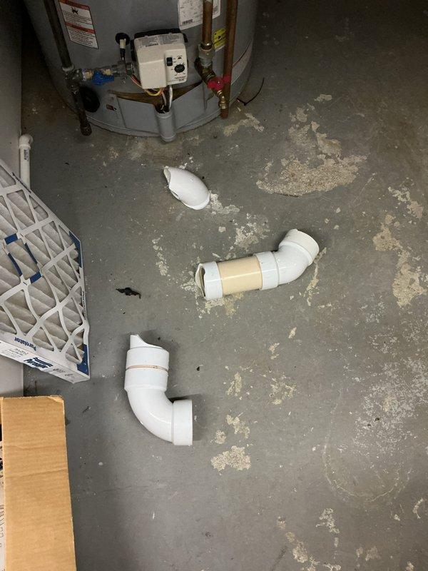 Responded to complaint of exhaust fumes from water heater leaking into living space. Upon inspection, identified compromised venting system on tanked water heater allowing combustion gases to escape into the home rather than properly exhausting outside. Disassembled and replaced defective PVC vent piping components, including multiple elbow fittings that showed signs of deterioration and mineral deposits. Reinstalled proper venting configuration to ensure safe exhaust of combustion gases and verified all connections were secure and properly sealed to prevent future leakage into occupied areas.