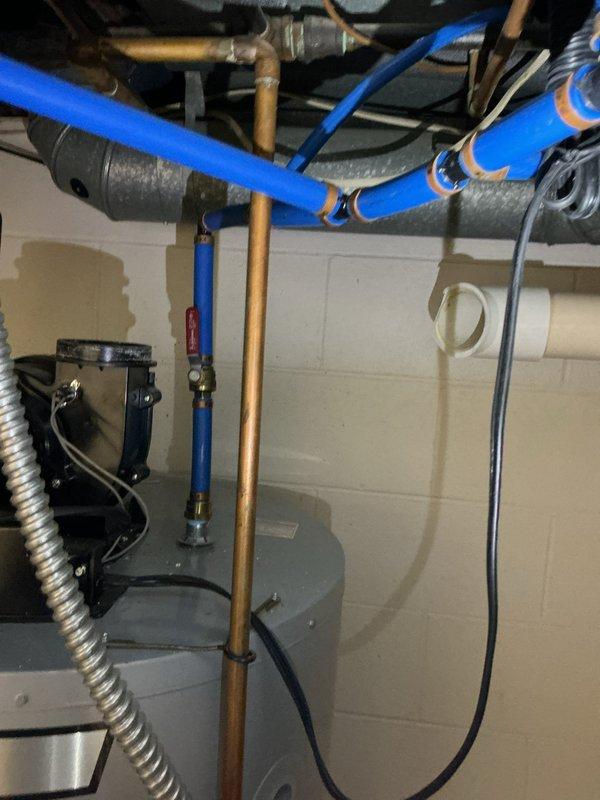 Responded to complaint of exhaust fumes from water heater leaking into living space. Upon inspection, identified compromised venting system on tanked water heater allowing combustion gases to escape into the home rather than properly exhausting outside. Disassembled and replaced defective PVC vent piping components, including multiple elbow fittings that showed signs of deterioration and mineral deposits. Reinstalled proper venting configuration to ensure safe exhaust of combustion gases and verified all connections were secure and properly sealed to prevent future leakage into occupied areas.