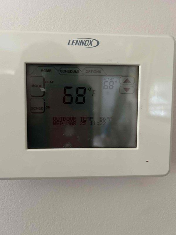 Responded to service call for Lennox thermostat displaying outdoor sensor error message. Upon arrival, confirmed system was operating in heating mode and maintaining setpoint of 68°F, but thermostat display indicated outdoor temperature sensor malfunction. Inspected outdoor condenser unit and associated wiring connections, verified refrigerant lines and electrical connections were secure. Diagnosed faulty outdoor ambient temperature sensor preventing proper communication with thermostat control board. No parts replaced or repairs performed during this diagnostic visit.