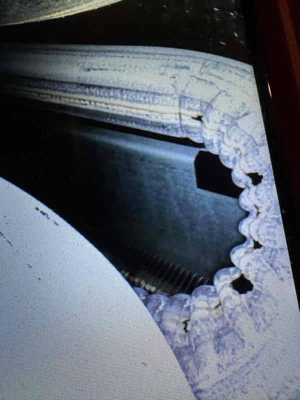Responded to service call for second opinion on CO2 leak on 21-year-old furnace system located in basement. Upon inspection, discovered significant structural damage to air handler/ductwork with large irregular hole in side panel, compromising system integrity and creating potential for combustion gas leakage. Performed diagnostic testing using digital combustion analyzer to assess carbon monoxide and carbon dioxide levels. Documented extensive deterioration of ductwork with jagged metal edges and compromised seals. Noted water staining on concrete floor surrounding furnace base, indicating possible condensate drainage issues that may have contributed to metal corrosion over time. Photographed damaged components for documentation purposes. Given the age of equipment and extent of structural damage to critical components, advised customer that repair would require replacement of damaged ductwork sections and thorough evaluation of heat exchanger integrity to ensure safe operation and pr