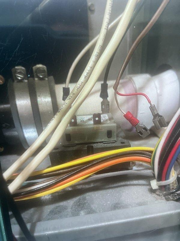 Responded to no heat call at residential property. Upon inspection of furnace located in utility room, discovered electrical wiring issues within the blower compartment and significant debris accumulation on heat exchanger tubes. Inspected all electrical connections, terminal blocks, and capacitor assembly. Documented condition of internal components showing signs of age and operational wear. Cleaned debris from heat exchanger surfaces and verified proper wire routing and connections throughout electrical compartment. System evaluated for safety and operational concerns.