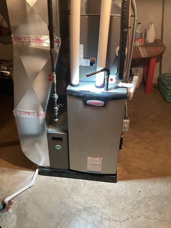 Completed annual heating maintenance on residential Lennox furnace system in basement utility area. Performed comprehensive tune-up inspection of all major components including heat exchanger, burner assembly, blower motor, and electrical connections. Verified proper operation of safety controls, tested ignition sequence, and confirmed adequate airflow through supply and return ductwork. Inspected ductwork connections and foil tape seals for integrity. System operating within manufacturer specifications with no deficiencies noted at time of service.