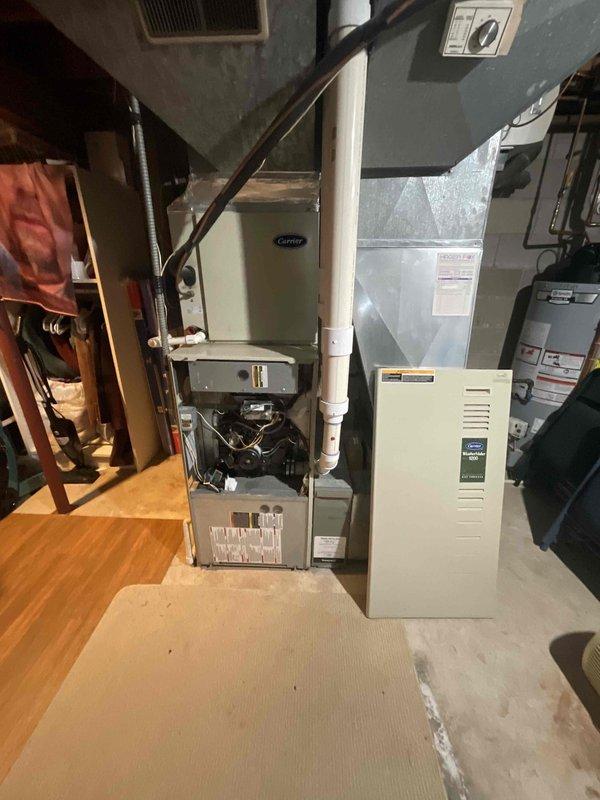 Provided comprehensive estimate for replacement of 20-year-old Carrier furnace and air conditioning system located in basement mechanical room. Current natural gas furnace and AC unit are operational but nearing end of service life. Evaluated existing HVAC configuration, ductwork layout, electrical panel capacity, and venting system to determine appropriate replacement equipment specifications and installation requirements.