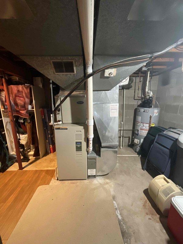 Provided comprehensive estimate for replacement of 20-year-old Carrier furnace and air conditioning system located in basement mechanical room. Current natural gas furnace and AC unit are operational but nearing end of service life. Evaluated existing HVAC configuration, ductwork layout, electrical panel capacity, and venting system to determine appropriate replacement equipment specifications and installation requirements.
