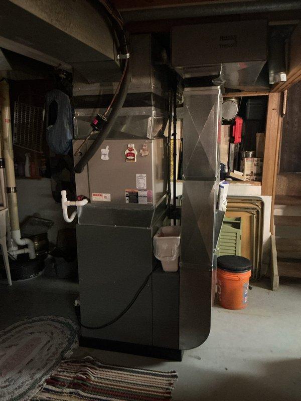 Completed scheduled Air Care Maintenance on residential split HVAC system. Inspected outdoor condenser unit on concrete pad, verified proper airflow through louvered panels and protective grille, and assessed overall equipment condition. Performed indoor inspection of furnace and air handler in basement utility area, checked ductwork connections, condensate drainage system, and electrical components to ensure system readiness for cooling season.