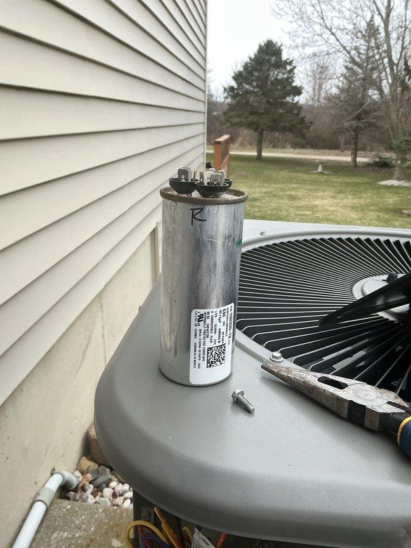 Completed comprehensive ComfortGuard maintenance visit on residential outdoor HVAC system. Performed thorough inspection of condenser unit, including examination of capacitor with visible terminals and connections, verified proper electrical conduit routing, and assessed PVC condensate line installation. Unit components showed normal wear consistent with regular operation, all electrical connections secure, and system operating within manufacturer specifications.
