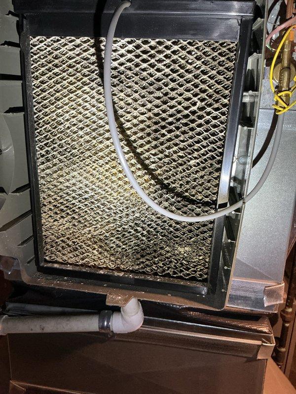 Completed annual HVAC maintenance service on air handling system. Inspected heavily soiled air filter showing significant dust and debris accumulation with uneven discoloration across the filter media. Replaced dirty filter with new unit to restore proper airflow and system efficiency. Verified all mechanical components, refrigerant lines, electrical connections, and condensate drain system operating within normal parameters.