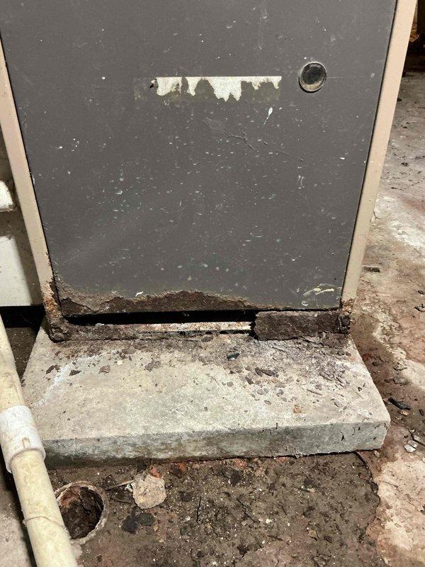 Responded to service call for communication issues between thermostat and furnace located in basement. Upon inspection, found significant rust and corrosion on furnace cabinet and internal components, indicating age-related deterioration. Examined control board wiring connections and traced communication failure to compromised wire connections affected by moisture exposure and cabinet corrosion. Documented equipment condition showing extensive oxidation on metal housing, deteriorated cabinet base where unit meets concrete pad, and multiple wire splices with aging connectors. Recommended system evaluation due to advanced corrosion affecting electrical components and cabinet integrity, which poses reliability concerns for continued operation.