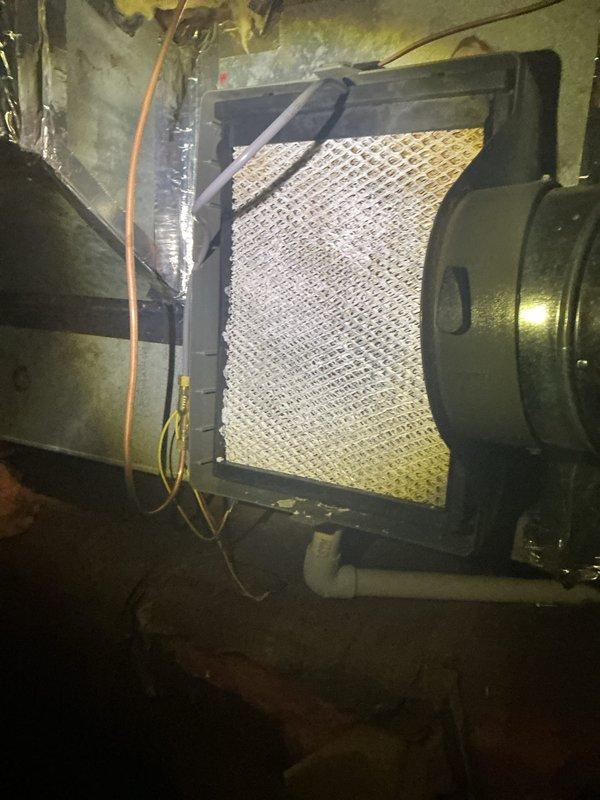 Completed routine air handler maintenance inspection and filter replacement. Accessed air handler unit in basement utility area, removed and replaced dirty pleated air filter showing visible dust and debris accumulation. Verified proper filter installation in frame, inspected blower motor housing, electrical connections, and associated ductwork for proper operation. System operational upon completion.