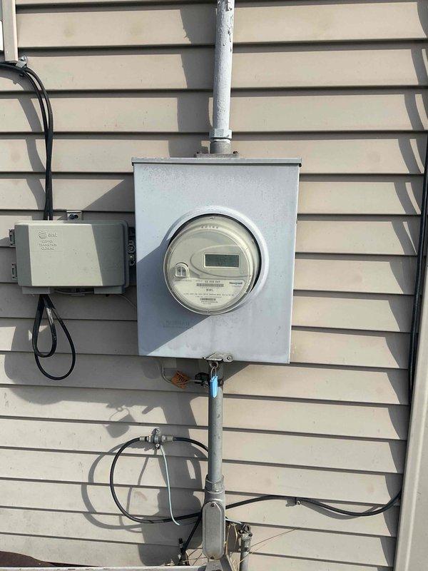 Conducted comprehensive site evaluation for complete HVAC system replacement including furnace and air conditioning unit. Current equipment is operational but aged beyond recommended service life, with furnace located in basement and outdoor condensing unit positioned in side yard. Documented existing electrical service entrance configuration, outdoor unit placement, and accessibility conditions to develop accurate replacement specifications and installation requirements.