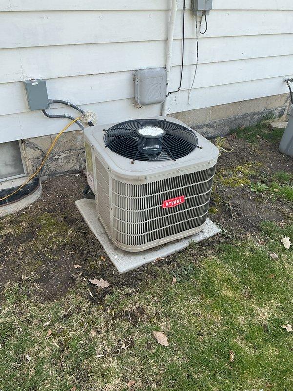 Completed annual cooling maintenance on Bryant outdoor condensing unit. Inspected electrical connections and disconnect box, verified proper mounting and levelness on concrete pad, and assessed overall system condition. Unit operational with normal weathering present; documented equipment status with photos for service records.