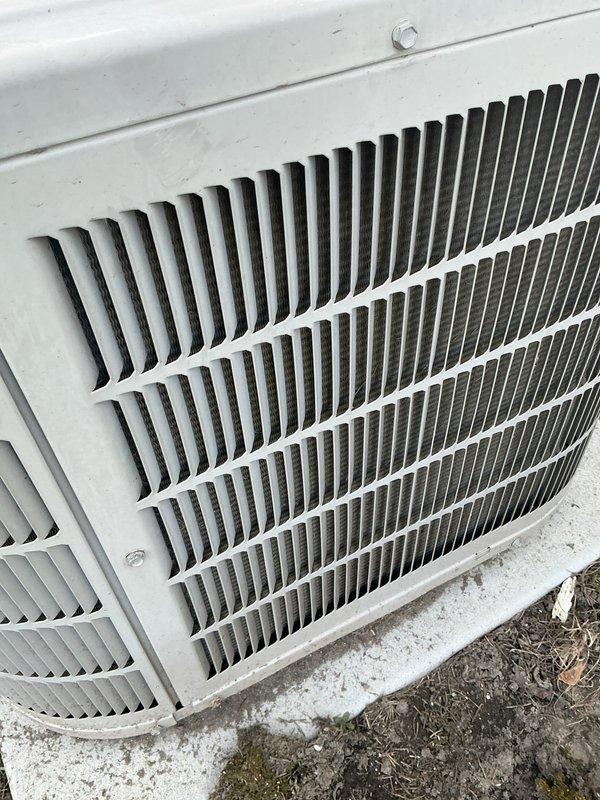Completed annual cooling maintenance on Bryant outdoor condensing unit. Inspected electrical connections and disconnect box, verified proper mounting and levelness on concrete pad, and assessed overall system condition. Unit operational with normal weathering present; documented equipment status with photos for service records.