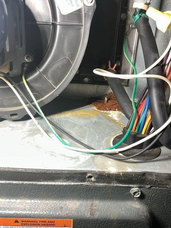 Responded to post-flood furnace inspection request. Performed thorough visual examination of all accessible furnace components including blower assembly, electrical connections, and cabinet interior. Documented evidence of water exposure with visible corrosion on metal surfaces and mineral deposits on base pan. Blower motor and housing showed operational wear but no immediate water damage. All wiring harnesses and electrical connections were inspected for moisture intrusion and found intact. Advised homeowner of observed corrosion and potential future concerns related to flood exposure, recommending continued monitoring of unit performance.