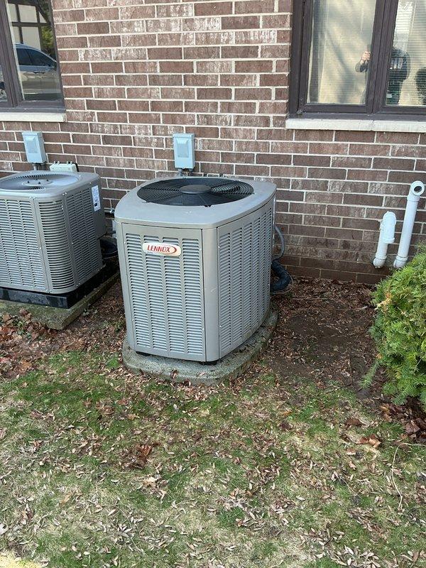 # HVAC Maintenance - ACM Completed

Performed annual cooling maintenance on two Lennox outdoor condensing units located at the rear of the property. Conducted comprehensive inspection of both systems including visual assessment of cabinet condition, refrigerant line connections, and electrical components. Verified proper operation of condenser fan motors and compressors on both units.

Inspected outdoor units for debris accumulation, proper airflow clearance, and potential obstructions around louvered panels. Noted ground conditions around equipment pads showing adequate drainage and stable mounting. Checked electrical disconnect boxes mounted on exterior wall for proper function and secure connections.

Documented current filter specifications requiring HCF16-11 (MERV 11) replacement. Photographed equipment condition and positioning for maintenance records. Both Lennox units showed normal wear patterns consistent with regular operation. All accessible components inspected and found to