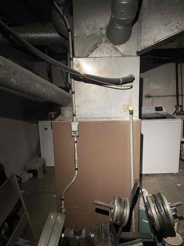 Conducted on-site assessment of existing 53-year-old furnace system originally installed in 1973 for replacement quotation. Evaluated current heating equipment condition, documented existing ductwork connections, refrigerant lines, and condensate drainage components in basement mechanical room, and captured photographic documentation of installation environment to provide comprehensive replacement estimate.