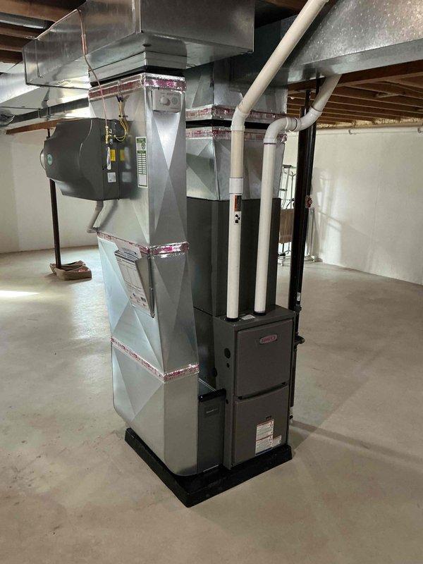 Completed full HVAC system installation including a 70,000 BTU gas furnace with integrated humidifier in the basement and a 2.5-ton air conditioning condenser unit positioned on a platform pad in the side yard. Installed all necessary ductwork, refrigerant lines, electrical conduit, condensate drain lines, and PVC venting to connect both systems. Reconnected existing components and ensured proper airflow distribution throughout the residence, with all equipment mounted on protective platforms and secured according to manufacturer specifications and local mechanical permit requirements.