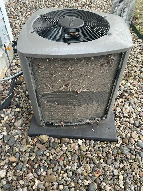 Completed annual cooling maintenance on outdoor condenser unit. Upon arrival, found heat exchanger coils heavily clogged with dirt, dust, and organic debris significantly restricting airflow. Thoroughly cleaned and flushed condenser coils to restore proper heat transfer efficiency. Inspected fan motor operation, electrical connections, and refrigerant lines. Verified unit returned to optimal operating condition with improved airflow through coil surfaces.
