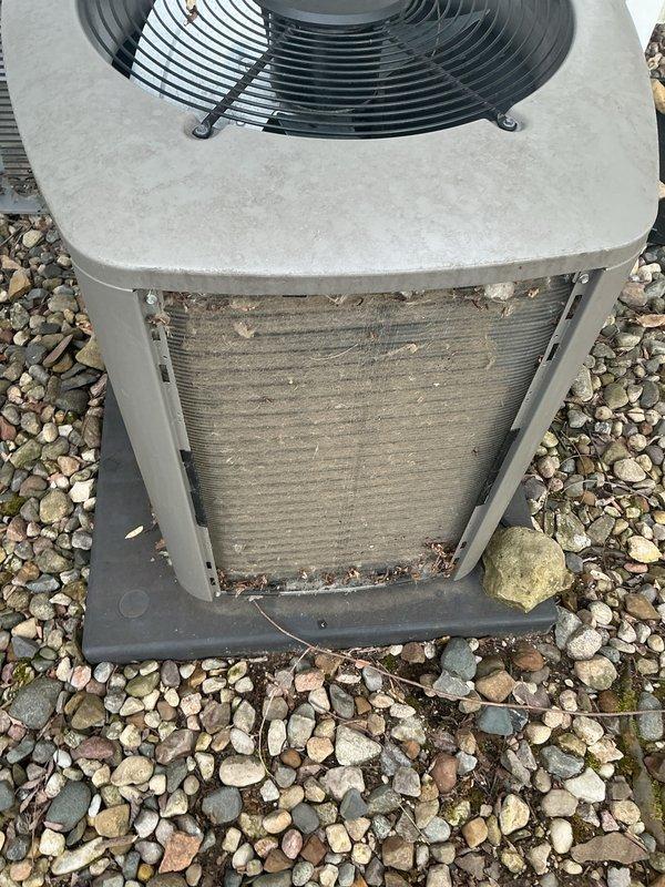 Completed annual cooling maintenance on outdoor condenser unit. Upon arrival, found heat exchanger coils heavily clogged with dirt, dust, and organic debris significantly restricting airflow. Thoroughly cleaned and flushed condenser coils to restore proper heat transfer efficiency. Inspected fan motor operation, electrical connections, and refrigerant lines. Verified unit returned to optimal operating condition with improved airflow through coil surfaces.
