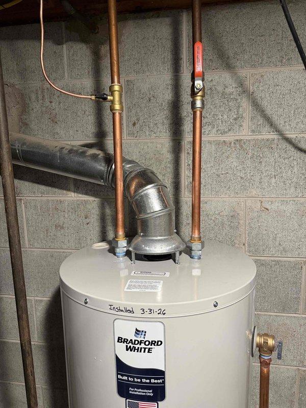 Successfully installed a 40-gallon Bradford White natural draft water heater, model RG240S6N, in basement utility room. Completed all copper piping connections to the unit, including hot and cold water lines with appropriate shut-off valves and pressure relief valve installation. Connected natural draft flue venting system to existing vent stack for proper exhaust of combustion gases. Secured unit with proper mounting brackets on concrete floor and verified all plumbing connections for leak-free operation. Installation included electrical wiring connections and compliance with manufacturer specifications for professional installation requirements.