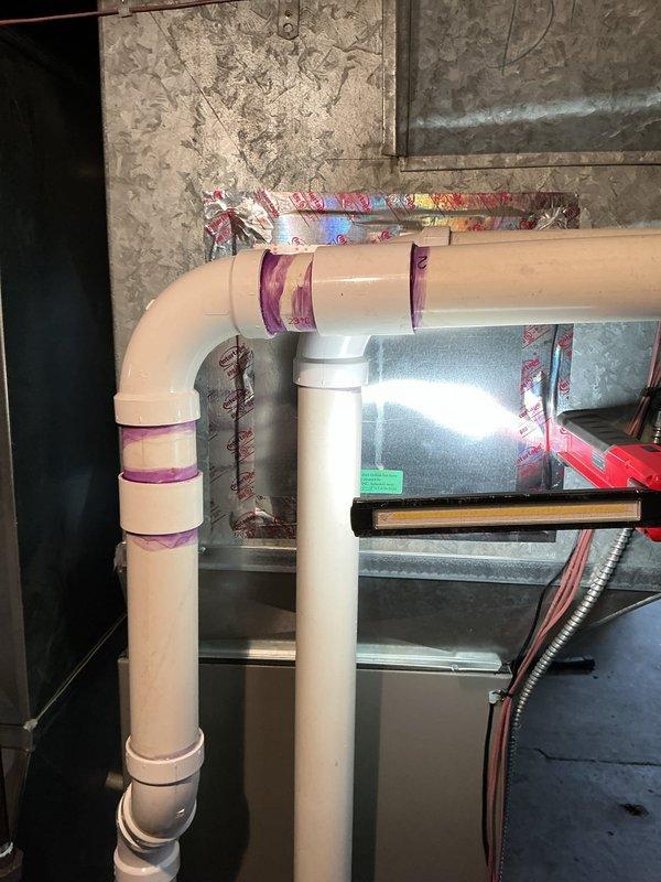 During a scheduled maintenance appointment, a water leak was discovered on the furnace exhaust vent pipe. The leak was identified at the PVC piping configuration, and necessary repairs were completed with replacement parts and labor to restore proper system operation and prevent further water damage.