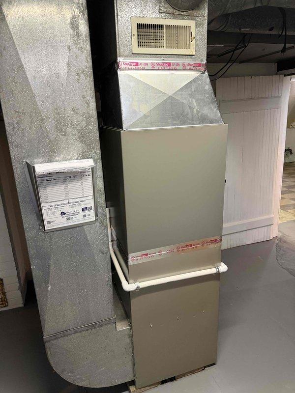 Completed full installation of 2-ton Lennox air conditioning system with matching evaporator coil at residential property. Installed outdoor condensing unit on concrete pad with proper refrigerant line connections and electrical hookup, positioned at rear of structure with adequate clearance for airflow and service access. Mounted new evaporator coil to existing furnace system in basement utility area, connected refrigerant lines through exterior wall penetration, and completed all necessary ductwork connections. Obtained required mechanical and air conditioning permits prior to installation. Verified proper refrigerant charge, tested system operation for cooling performance, and confirmed all electrical connections meet code requirements.