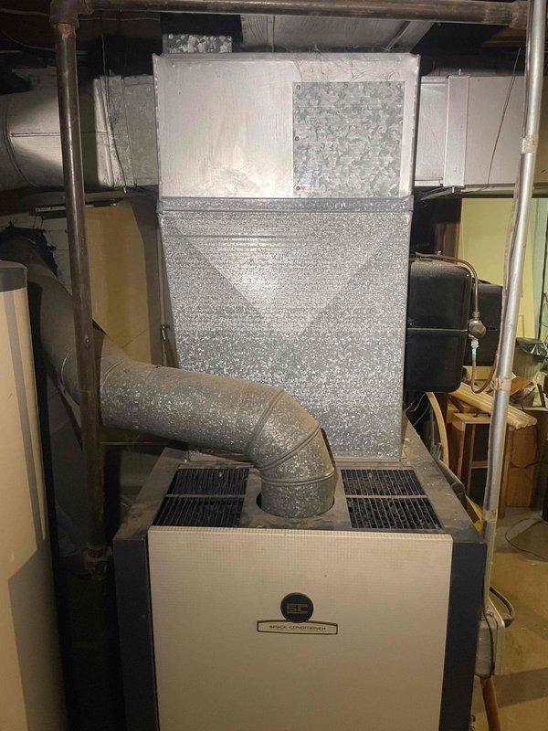 Conducted comprehensive assessment of existing basement HVAC system including natural gas furnace, air conditioning components, and water heater for equipment replacement quotation. Evaluated current operational status of functioning furnace unit, inspected ductwork showing significant condensation accumulation on metal surfaces and elbow connectors, and documented insulated supply lines and existing mechanical configurations. Prepared separate replacement estimates for furnace and water heater combination, standalone air conditioning unit, and individual component options as requested.