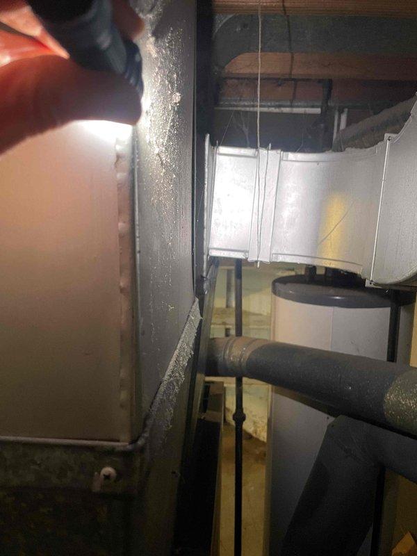 Conducted comprehensive assessment of existing basement HVAC system including natural gas furnace, air conditioning components, and water heater for equipment replacement quotation. Evaluated current operational status of functioning furnace unit, inspected ductwork showing significant condensation accumulation on metal surfaces and elbow connectors, and documented insulated supply lines and existing mechanical configurations. Prepared separate replacement estimates for furnace and water heater combination, standalone air conditioning unit, and individual component options as requested.