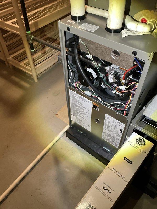 Completed comprehensive ComfortGuard maintenance visit including furnace filter replacement and full system inspection. Accessed furnace unit and replaced air filter to maintain optimal airflow and system efficiency. Performed UV light inspection of evaporator coil, which revealed significant biological growth and organic contamination throughout the coil fins and serpentine copper tubing, particularly concentrated in upper and middle sections. Documented findings with standard and UV photography for customer records. Recommended professional coil cleaning to restore heat transfer efficiency and prevent reduced cooling capacity and potential system strain.