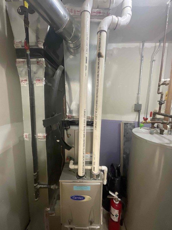 Provided comprehensive estimate for replacement of one Carrier residential forced air furnace located in commercial mechanical room. The mechanical room currently houses three HVAC units, with only one requiring replacement at this time. Evaluated existing equipment configuration including white PVC intake and exhaust venting, ductwork connections, and utility clearances in preparation for furnace changeout.