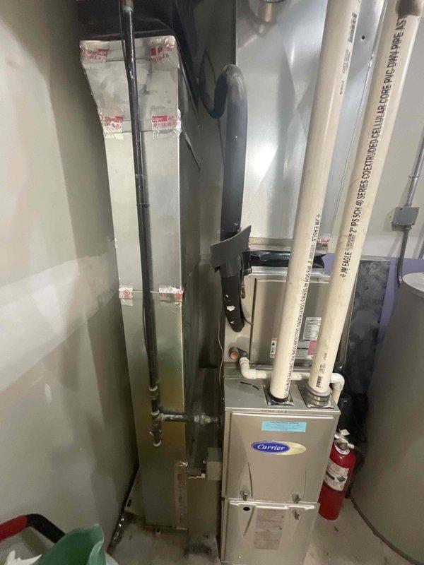 Provided comprehensive estimate for replacement of one Carrier residential forced air furnace located in commercial mechanical room. The mechanical room currently houses three HVAC units, with only one requiring replacement at this time. Evaluated existing equipment configuration including white PVC intake and exhaust venting, ductwork connections, and utility clearances in preparation for furnace changeout.