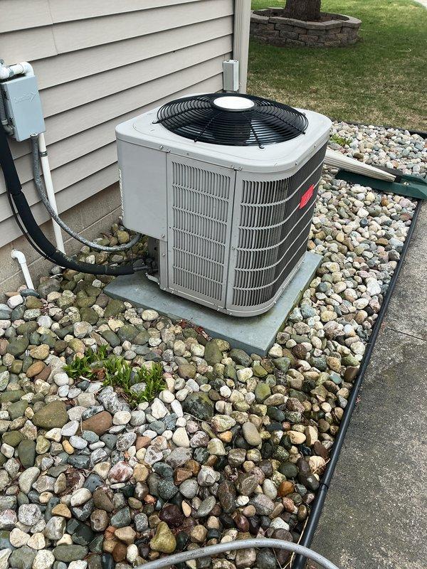 Completed routine maintenance on a 7-year-old central air conditioning system. Performed comprehensive tune-up including inspection of outdoor condensing unit, verified proper operation of compressor and condenser fan, checked refrigerant lines and electrical connections at disconnect box, cleaned condenser coils, and confirmed system is cooling effectively. Unit found in good working condition with no issues identified during service visit.