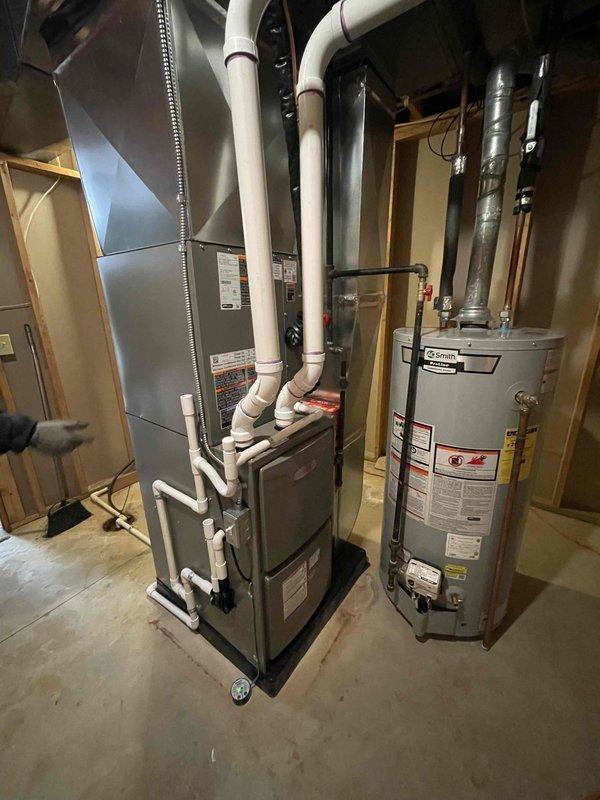 Completed full HVAC system installation including a 70,000 BTU gas furnace (model ML19601170XE-36N) and 2.5 ton air conditioning unit with outdoor condenser (model CK40CT-30B-71). Installed new furnace on platform in basement mechanical room with left-side configuration, connected PVC venting system, established proper condensate drainage with 3/4" PVC drain line, and ran copper refrigerant lines to outdoor unit. Installed 30-amp disconnect, verified 25-amp electrical connections with proper breaker protection, and reconnected all ductwork including flexible connector to existing distribution system. All permits obtained prior to installation, system tested and operational upon completion.