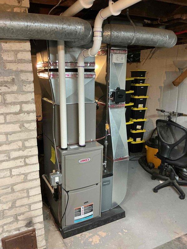 Completed full HVAC system installation in basement utility room, including new Lennox furnace unit (45,000 BTU capacity) mounted on platform with humidifier and liner. Installed 1.5 ton air conditioning system with rear discharge configuration. Ran new PVC vent piping vertically from furnace top for proper ventilation and drainage. Connected galvanized metal supply ductwork and installed necessary return air components. Established new dedicated electrical circuit to code for system operation. Mechanical and electrical permits obtained prior to installation. All equipment properly positioned, secured, and connected to existing infrastructure. System tested and verified operational upon completion.