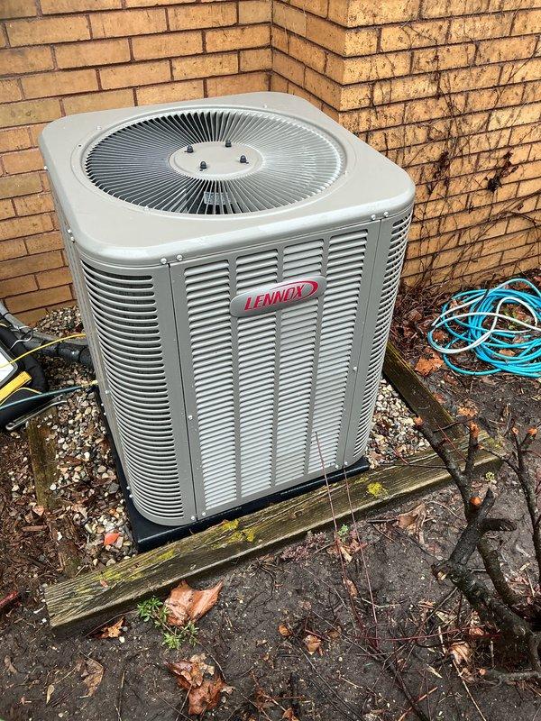 Completed annual air conditioning maintenance on Lennox condenser unit per membership agreement. Performed comprehensive AC tune-up including system inspection, cleaning of outdoor unit and surrounding area which had accumulated seasonal debris and leaves, checked refrigerant levels and lines, tested electrical components, verified proper airflow through louvers and fan operation, and confirmed system operating within manufacturer specifications. Unit showed no issues; all components functioning properly. Photos documented equipment condition and installation.
