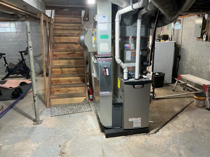 Completed full HVAC system installation in basement mechanical room, including 70,000 BTU furnace and 2-ton air conditioning unit with rear discharge configuration. Installed all necessary ductwork connections, integrated whole-home humidifier into system, and reconnected existing utilities. All equipment positioned and secured per manufacturer specifications, with proper clearances maintained for service access. Permits obtained prior to installation, and all work completed to code requirements. System tested and verified operational upon completion.