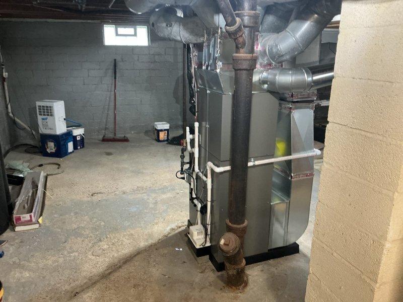 Completed full HVAC system installation in basement mechanical room, including 70,000 BTU furnace and 2-ton air conditioning unit with rear discharge configuration. Installed all necessary ductwork connections, integrated whole-home humidifier into system, and reconnected existing utilities. All equipment positioned and secured per manufacturer specifications, with proper clearances maintained for service access. Permits obtained prior to installation, and all work completed to code requirements. System tested and verified operational upon completion.