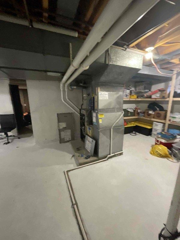 Completed on-site evaluation for non-operational natural gas furnace located in basement mechanical room. Assessed existing HVAC system configuration, including ductwork connections, venting arrangement through exterior wall with PVC exhaust termination, and current equipment layout in unfinished basement space. Documented system specifications and provided replacement recommendations based on existing infrastructure and customer heating requirements.