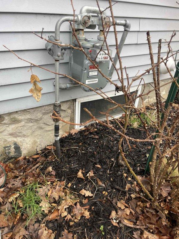 Conducted comprehensive site assessment for full HVAC system replacement and new whole home Generac generator installation. Evaluated existing non-functional air conditioning system, assessed furnace replacement requirements, and documented current gas meter location and configuration for generator integration planning. Photographed gas service infrastructure at exterior meter location and confirmed natural gas appliance compatibility with existing kitchen range to determine proper sizing and load calculations for proposed generator system.