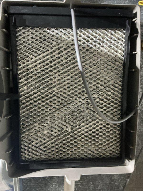 Completed annual preventive maintenance on two rooftop air conditioning units. Inspected and replaced humidifier filter pad showing significant mineral buildup and discoloration. Documented excessive frost accumulation in refrigeration unit interior, indicating potential door seal issue or defrost cycle malfunction requiring future attention. Replaced air filters as needed and verified system operation upon completion.