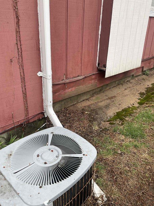 Conducted comprehensive assessment of aging HVAC system for replacement estimate, including 31-year-old furnace located in interior utility closet and outdoor central air conditioning condenser unit dating to approximately 1995. Documented existing equipment conditions through detailed photography, noting the Oasis-branded furnace with metallic ductwork configuration and water heater proximity constraints in confined mechanical room space. Evaluated exterior AC condenser unit showing significant weathering, rust formation, and discoloration consistent with extended service life, along with associated PVC drainage line routing and concrete pad placement. Provided replacement options and prepared estimate for complete system upgrade to address end-of-life equipment requiring immediate attention.